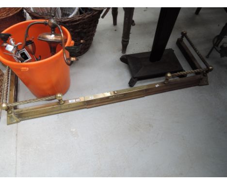 A traditional brass fire fender and copper light fitting etc