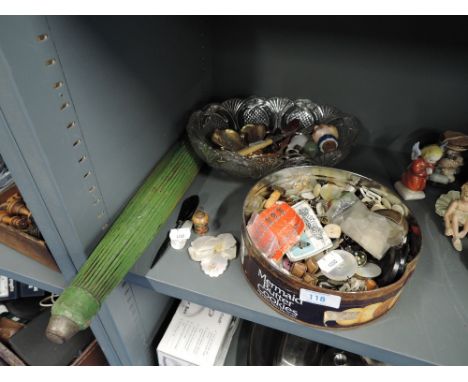 A selection of curios and trinkets including decorated parasol and button selection