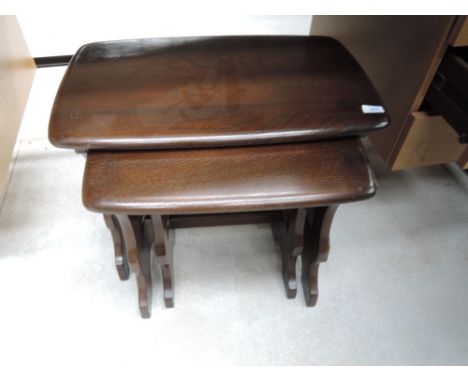A Priory/Ercol style dark stain nest of three tables
