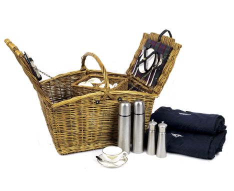 A Bentley four-person wicker-cased picnic hamper, by Gadsby &amp; Co,with wicker loop handle, double-lid opening to reveal ta