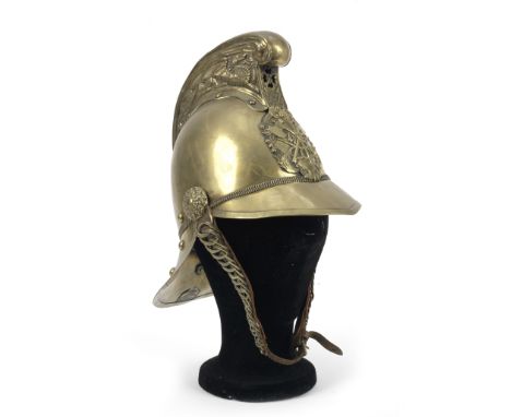A brass fireman's helmet by Merryweather &amp; Sons of London, late 19th/early 20th Century,the comb (slight dent) with pierc