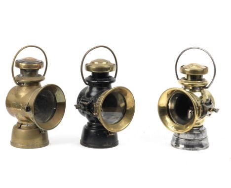 A near pair of Lucas No.722 oil-illuminating side-lamps,brass bodies, one Japanned black, spade mounting, with 4 inch clear l
