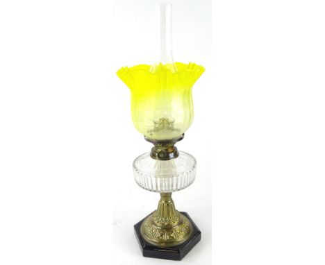 An early 20thC oil lamp, with clear funnel marked fire proof, with bear stamp, yellow clear and etched glass shade, brass sho