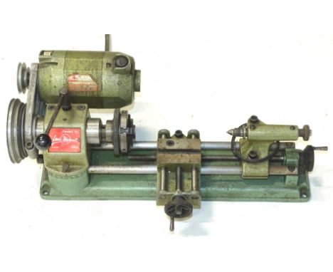 A vintage Austrian MCo Unimat lathe, model SL 220v TYPUG7750, 16cm high, 38cm wide, 17cm deep.