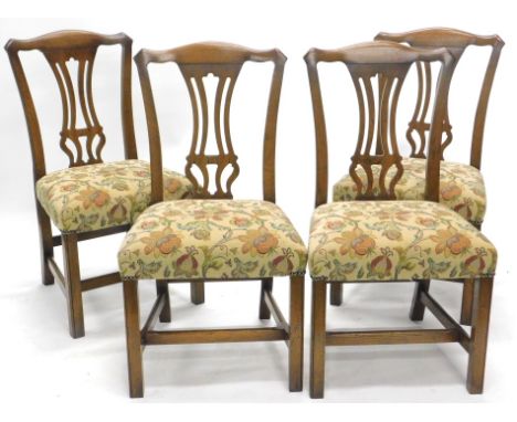 A set of four Reprodux oak Chippendale design dining chairs, each with shaped cresting rails, inverted pierced back splats, o