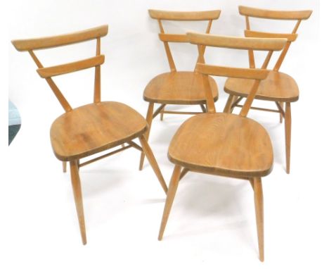A set of four vintage late 1960's/early 1970's Ercol style elm dining chairs, each with tapering triangular backs, shaped sea