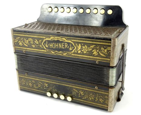 An early 20thC Hohner Marca accordion, with meshwork grill front, four upper and ten lower buttons, in floral decoration on a