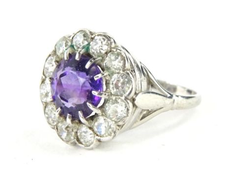 A floral cluster dress ring, set with amethyst and diamonds, florally claw set with a central amethyst stone, surrounded by s