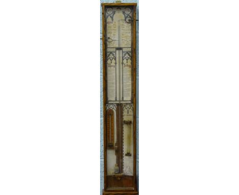 An Admiral Fitzroy oak cased barometer, of rectangular form, set with various thermometers, atmospheric glass dials, with a p