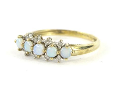 A 9ct gold dress ring, claw set with five opals and set with small white stones, on a part pierced shank, size N, 2g all in.