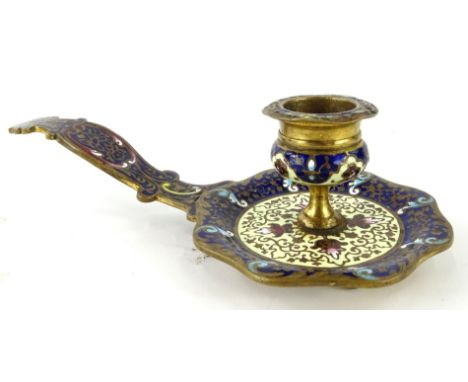 A Russian enamel taper stick, with a shaped bowl, circular bellied dish holder and shaped handle surmounted by a scroll and f