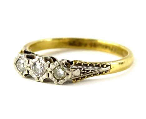 An 18ct gold and platinum diamond dress ring, set with three illusion set diamonds, in an Art Deco style setting, ring size M