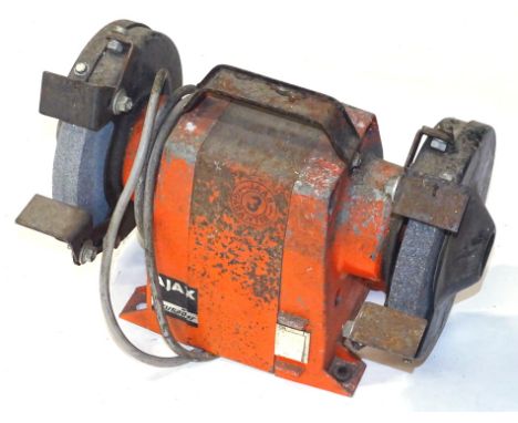 An Agax Crusader JAAR3 model DS7150T electric bench grinder, in orange, 24cm high, 31cm wide, 13cm deep.