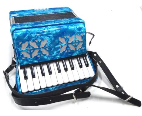 A child's piano accordion in blue, 29cm wide, in outer packaging.