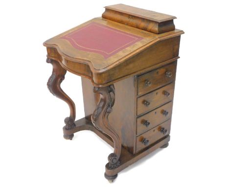 A Victorian figured walnut Davenport, the top with a raised hinged section for pens, etc., and a moulded slope inset with red