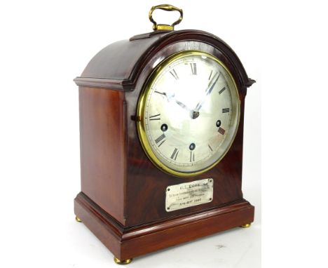 An early 20thC walnut and mahogany dome top bracket clock, the shaped case with gilt metal handle on compressed orb feet, fro