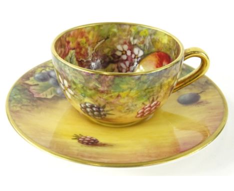 A 20thC Royal Worcester cabinet cup and saucer, by James Skerrett, hand painted with brambles and apples, the saucer 9cm diam