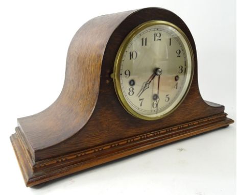 An early 20thC oak cased Napoleon hat mantel clock, the shaped case on compressed orb feet, with a 14cm diameter dial with Ar