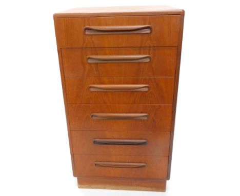 A vintage 1970's G-Plan teak narrow chest, of six long drawers, with moulded handles on a block base, labelled, 104cm high, 5