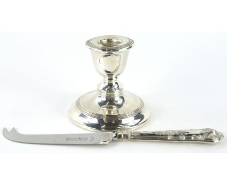 An Elizabeth II silver handled cheese knife, stylised kings pattern with shaped blade marked Stainless Steel, the handles She