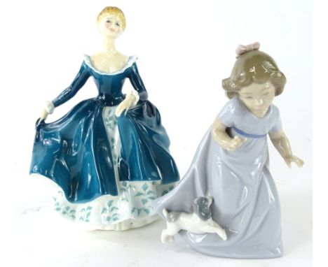 A Royal Doulton figure Janine, HN2461, printed marks beneath, 19cm high, and a Nao figure of a girl aside a puppy (2).