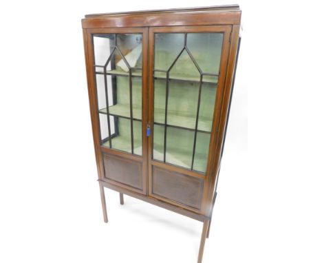 An Edwardian mahogany display cabinet, with caddy top, raised above a pair of astragal glazed doors, with a fitted interior, 