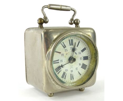 An early 20thC silver plated cased travel clock, with circular glass front in a square case with swing handle, on triple orb 