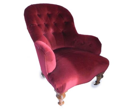 A Victorian walnut armchair, upholstered in red button fabric with a padded back, arms and serpentine seat, on turned taperin