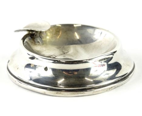 A 20thC silver ashtray, of circular form, with pipe rest, marks badly worn, 8cm wide, 6oz all in (AF, weighted).