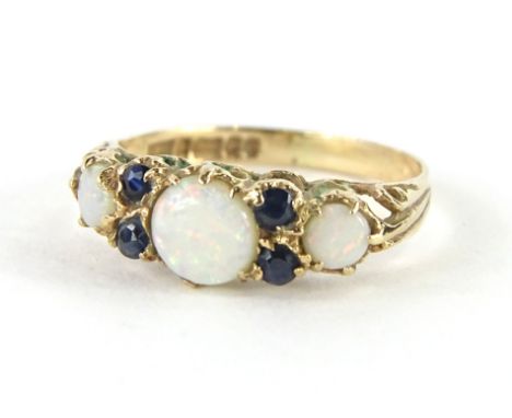 A 9ct gold dress ring, set with opals and small blue stones, on a part pierced shank, size K, 1.4g all in.