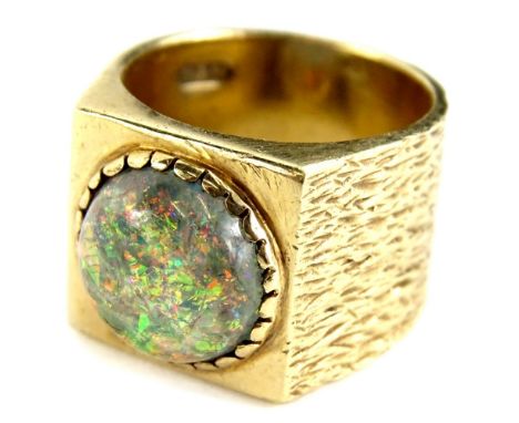 A 9ct gold signet ring, with central circular imitation fire opal, with bark effect design band, with plain square top, maker