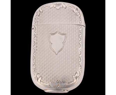 A Victorian silver Vesta case, T May & Co, Birmingham 1884, oval form with allover engine turned decoration, invisible hinge 