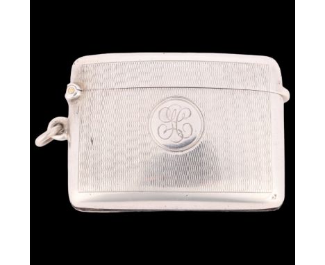 A George V silver Vesta case, A&J Zimmerman, Birmingham 1911, curved rectangular form with allover engine turned decoration a