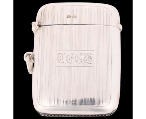 A George V silver Vesta case, indistinct maker, Birmingham 1919, curved rectangular form with allover engine turned decoratio