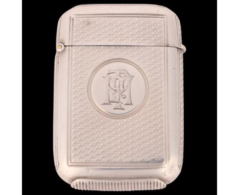 A late Victorian silver Vesta case, Goldsmiths & Silversmiths Co, London 1889, rounded rectangular form with allover engine t