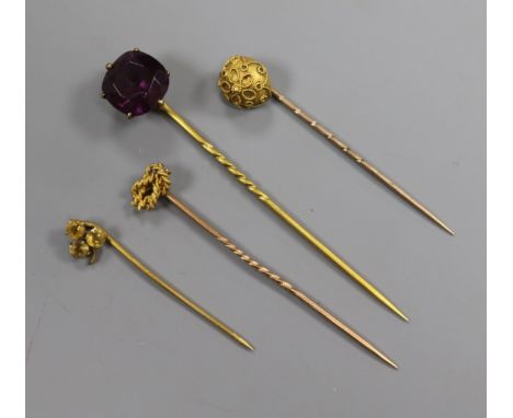 An early 20th century 15ct gold stick pin and three other assorted stick pins.