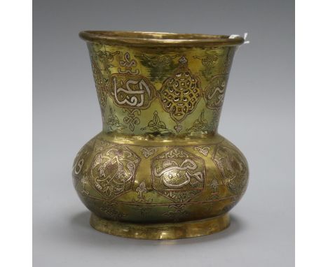 A Cairo ware brass vase, in the form of a mosque lamp, having wide tapered neck with pierced panels and engraved decoration, 