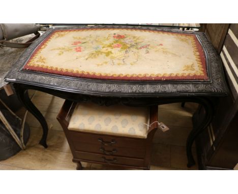 A 19th century French black painted centre table, with tapestry top W.120cm