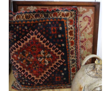 A framed tapestry and a carpet cushion