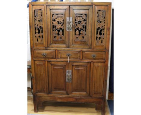 A Chinese carved and pierced wood cabinet W.120cm