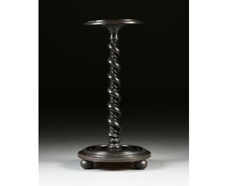 A VICTORIAN EBONIZED AND CARVED WOOD PEDESTAL STAND, SECOND HALF 19TH CENTURY, with a circular top enclosed by molded trim on