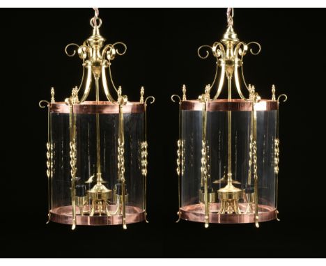 A PAIR OF REGENCY STYLE BRASS, COPPER, AND GLASS FOUR-LIGHT HALL LANTERNS, EARLY/MID 20TH CENTURY, with a suspension loop on 