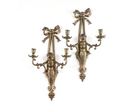 A PAIR OF LOUIS XVI STYLE GILT METAL TWO LIGHT FIGURAL SCONCES, 20TH CENTURY, each with a bow ribbon tied cast backplate susp