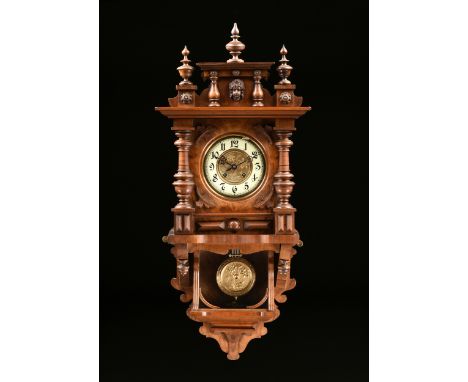 A GUSTAV BECKER CARVED WALNUT WALL CLOCK, MARKED, GERMAN, 1877-1926, with three vasi-form turned finials on a stepped cornice