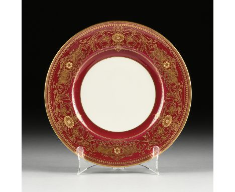 A SET OF TWELVE ROYAL WORCESTER PARCEL GILT BURGUNDY GROUND DINNER PLATES, MARKED, EARLY 20TH CENTURY, each with a gilt rim a