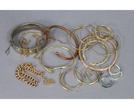 A 9ct. gold curb-link bracelet with a 9ct. gold padlock clasp; a 9ct. gold bangle; a silver hinged bracelet; &amp; various it