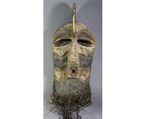 A large Songye Kifwebe male mask with curved crest, square protruding mouth, the sides with deep grooves &amp; traces of whit