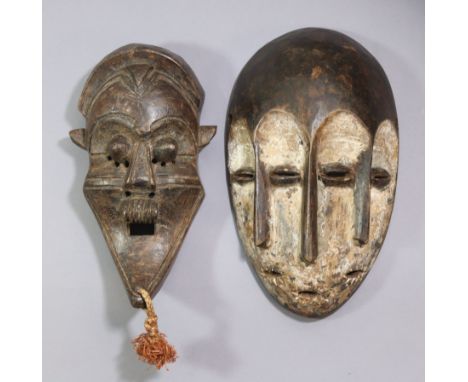 A Lega Bwami three-face mask, 10.5" &amp; another mask with protuding eyes &amp; long pointed chin, 9.25". Provenance: acquir