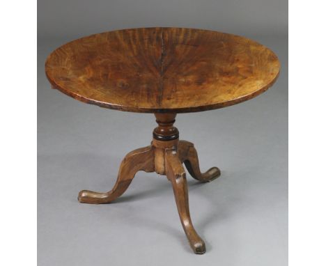 A mahogany tripod table with circular tilt-top, on vase-turned centre column &amp; three cabriole legs with pad feet, 32.25” 