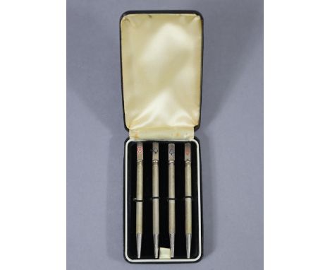 A set of four Sterling propelling Bridge pencils, each with block terminal engraved with one of the four playing card suits; 